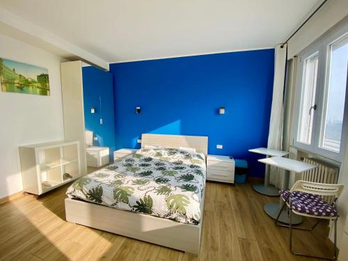 a blue bedroom with a bed and a blue wall at Venice Mestre Station House in Mestre