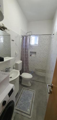 ein kleines Badezimmer mit Toilette und Dusche in der Unterkunft Blue Sea in Pirovac