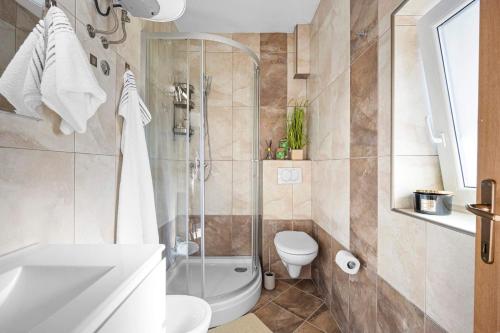 a bathroom with a shower and a toilet and a sink at Mamma's home in Trogir in Trogir