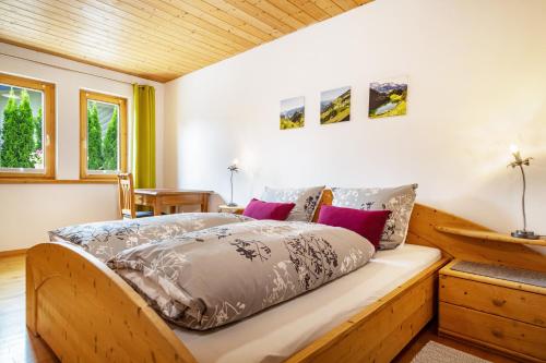 a bedroom with a wooden bed with pillows on it at Apartment Wesseling in Fontanella