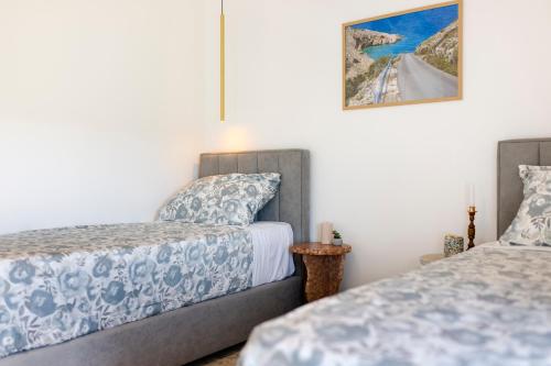 a bedroom with two beds and a painting on the wall at Analma in Belej