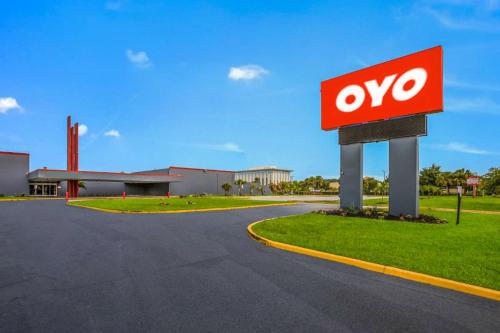 a sign for an oxy gas station on a road at OYO Hotel Orlando Airport in Orlando