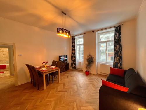 a living room with a table and a couch at Riverbridge Apartments Prague in Prague