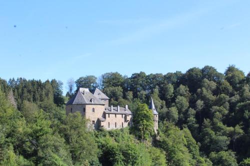 an old castle on the side of a hill at L'Écureuil - Terrasses de Malmedy in Malmedy