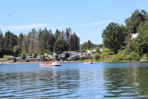 two boats on a lake with people in them at L'Écureuil - Terrasses de Malmedy in Malmedy