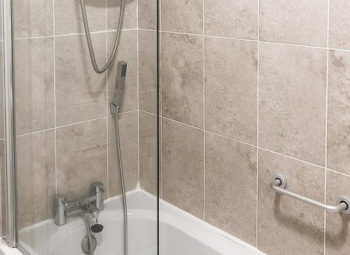 a shower with a phone in a bathroom at Old Court Holiday Homes 3 Bed - Sleeps 6 in Terryglass