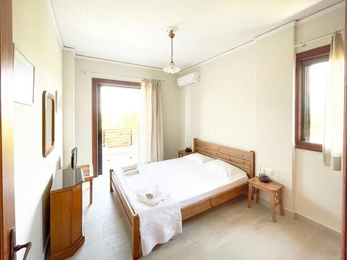 Postel nebo postele na pokoji v ubytování Malakassis House
