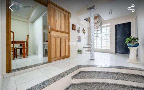a large room with a door and a vase on the floor at Krohberger Residence Hostel in Pomerode