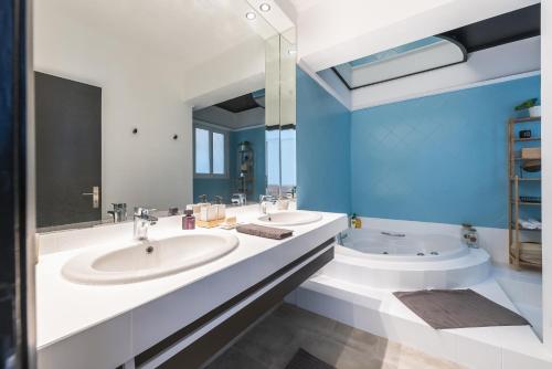 La salle de bains est pourvue de 2 lavabos et d'un grand miroir. dans l'établissement Private Loft Suite with stunning view of Acropolis, à Athènes
