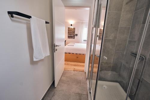 a bathroom with a shower and a walk in shower at Volcanic Boutique Hostel in Angra do Heroísmo
