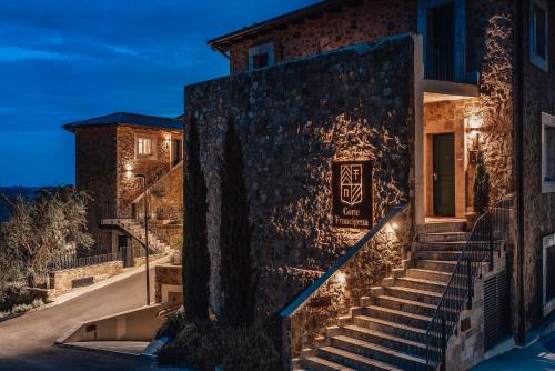 a building with stairs outside of it at night at Corte Francigena in Montalcino