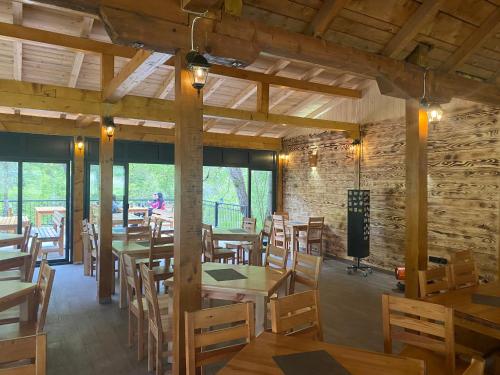 a dining room with wooden tables and chairs at Rafting Camp Tara 87 in Hum