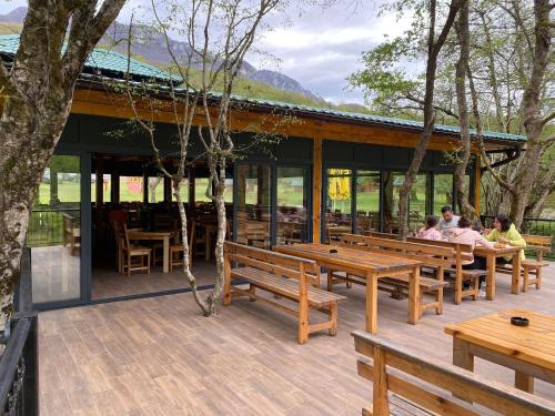 a group of people sitting at benches on a deck at Rafting Camp Tara 87 in Hum