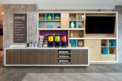 a display cabinet with a flat screen tv in a store at Home2 Suites By Hilton Vero Beach I-95 in West Vero Corridor