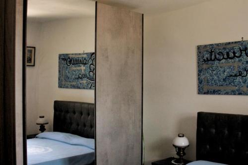 a mirror in a bedroom with a bed at Casa Scupoli Relax House Otranto in Otranto
