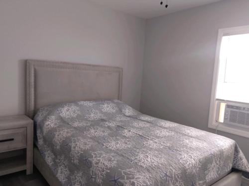 a bedroom with a bed and a window at Dupont Beach House C in Seaside Heights