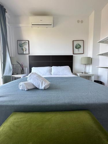 a bedroom with a large bed with two pillows on it at Plaza Spain Barcelona Apartments in Barcelona