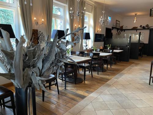 a restaurant with tables and chairs in a room at dS Hotel Gronau in Gronau