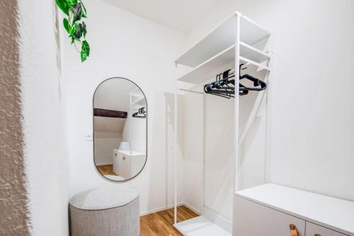 a dressing room with a mirror and a stool at Romantica Mansarda a Biasca 5* in Biasca