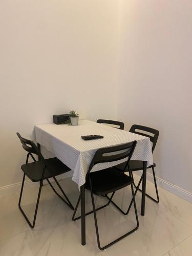 a table with chairs and a white table cloth on it at dana hotel apartments in Taif