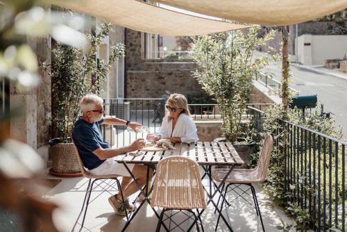 an older man and woman sitting at a table on a patio at Corte Francigena in Montalcino