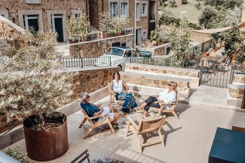 a group of people sitting in chairs on a patio at Corte Francigena in Montalcino