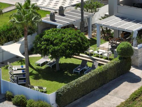 an overhead view of a building with chairs and trees at Sea La Vie in Adelianos Kampos