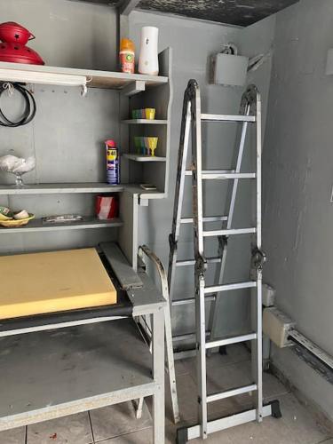 a ladder next to a shelf in a kitchen at Pinelopis House, Skala Sikamineas, Molivos, Midilli in Skála Sykaminéas