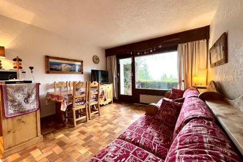 a living room with a large bed and a table at Cosy studio with garden and view of Mont Blanc in Saint-Gervais-les-Bains