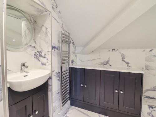 a bathroom with a sink and a mirror at Rock House Apartment in Newtown