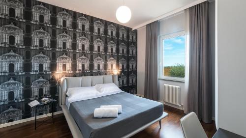 a bedroom with a bed and a wall with buildings at VILLA NINETTA 10&1, Emma Villas in Giulianova