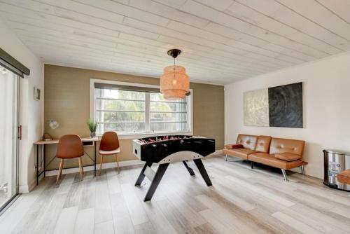a living room with a pool table and a couch at Boynton 3 2 Pool House in Boynton Beach