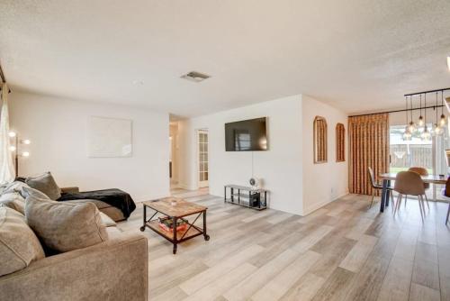 a living room with a couch and a table at Boynton 3 2 Pool House in Boynton Beach