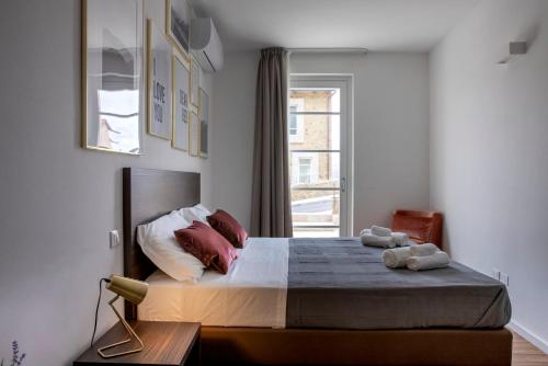 a bedroom with a large bed and a window at Corte Francigena in Montalcino