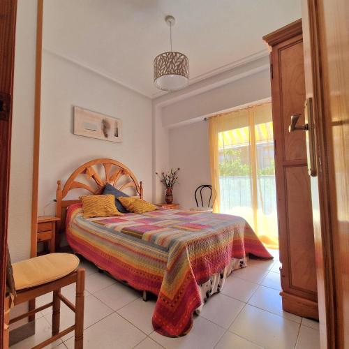 a bedroom with a bed and a window at Sol Apartment in Arenales del Sol