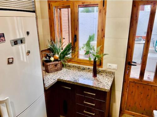 a kitchen with a counter and a window and a sink at Casa Merche in San José
