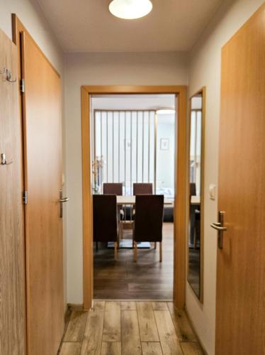 a hallway with a dining room with a table at Angela Domki i Pokoje in Pobierowo