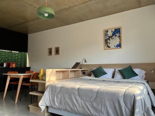 a bedroom with a bed and a table with a laptop at Primavera Suites in Buenos Aires