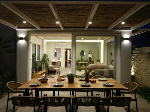 a dining room with a table and chairs at Sea La Vie in Adelianos Kampos