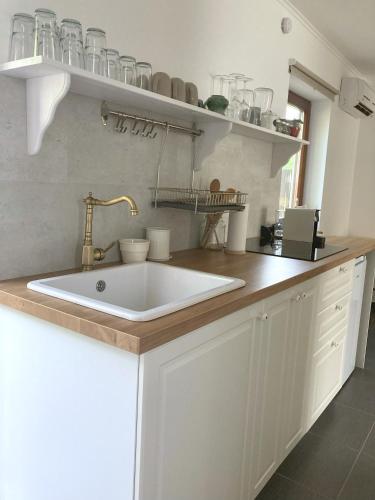 a kitchen with a white sink and a counter at Mi szél hozott in Lipót