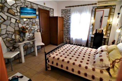 a bedroom with a bed and a table in a room at Pasas Castle - Unique Luxury Apartments in Naxos Chora