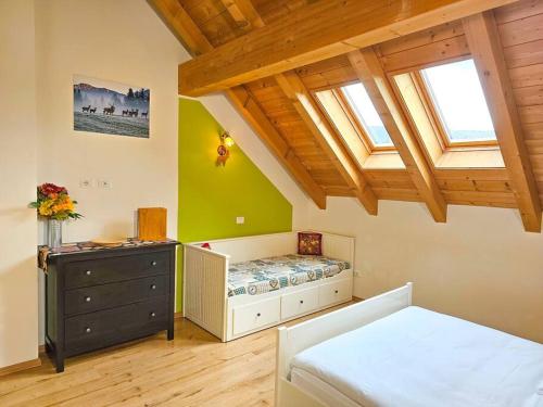 a bedroom with a bed and a dresser in a room at Agriturismo Filippon in Tambre dʼAlpago