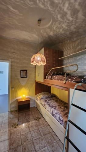 a bedroom with a bunk bed and a chandelier at Sea's Chalet in Fontane Bianche