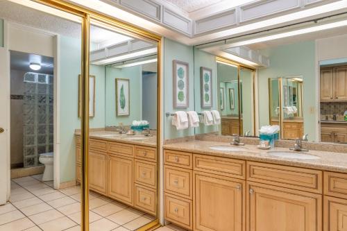 a bathroom with two sinks and two mirrors at Maui Kaanapali Villas #B143 condo in Lahaina