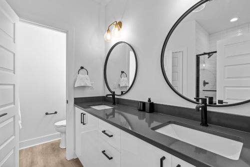 a bathroom with two sinks and a large mirror at 10 Ocean A Powered By Atkinson Realty in Virginia Beach