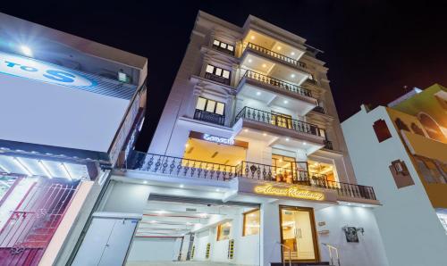 a tall white building with a sign on it at Treebo Aaravi Residency, 800 Mtrs From Promenade Beach in Puducherry