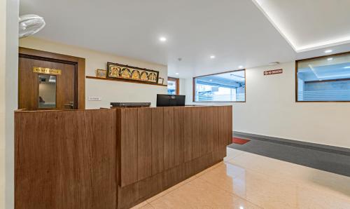 an office with a reception desk in a building at Treebo Aaravi Residency, 800 Mtrs From Promenade Beach in Puducherry