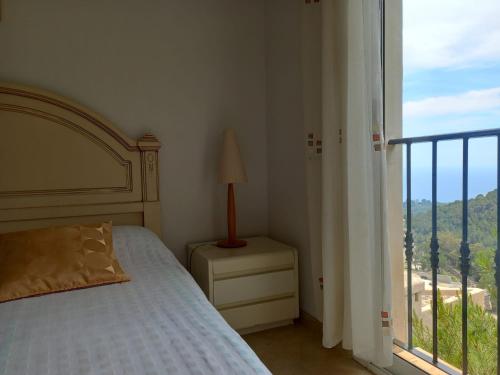 a bedroom with a bed and a large window at Villa Suiza in Altea