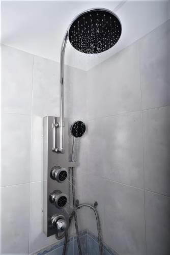 a shower with a shower head in a bathroom at Pasas Castle - Unique Luxury Apartments in Naxos Chora