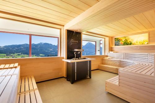 a sauna with two benches and two windows at AllgäuHotel Tanneck in Fischen